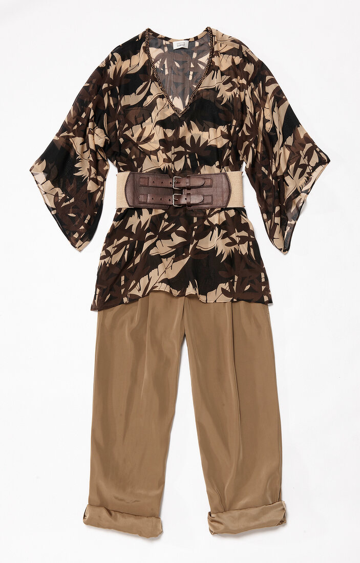 Silk tunic, baggy pants and wide belt on white background