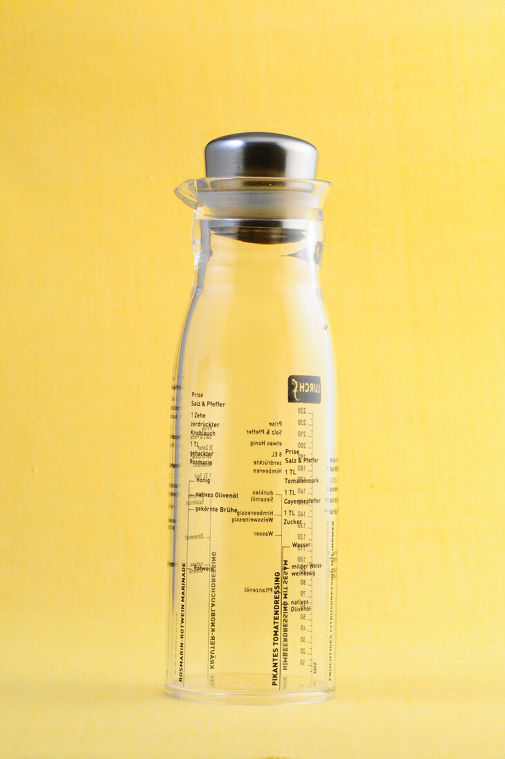 Measuring bottle on yellow background