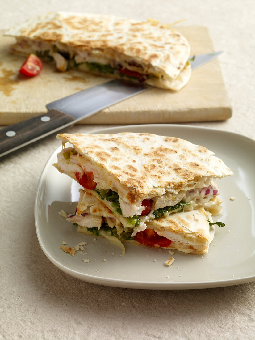 Close-up of quesadillas filled with chicken on plate 