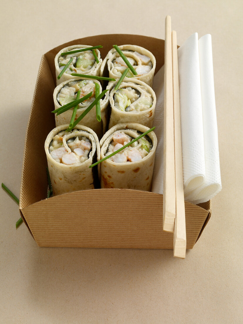 Close-up of sushi wrap with shrimp and avocado in box