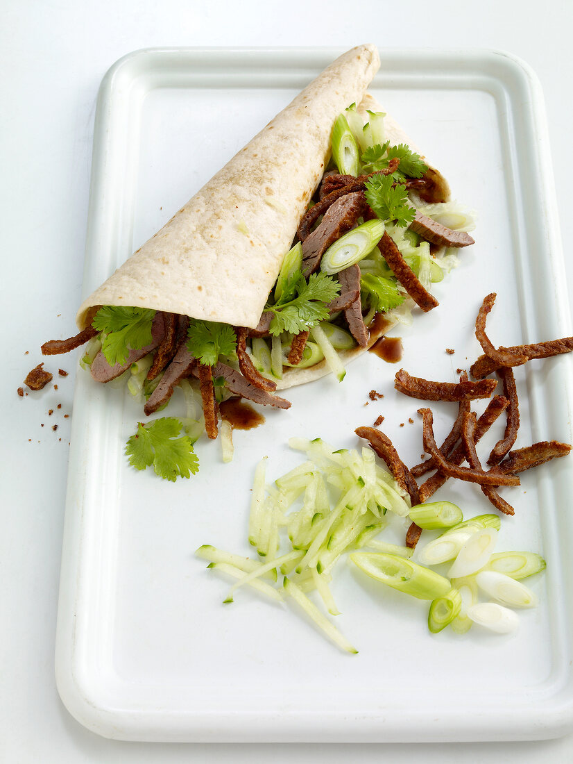 Close-up of wraps with peking duck on tray