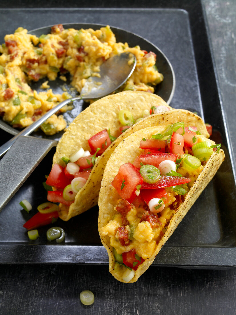 Close-up of taco shells with chorizo ??scrambled eggs on tray
