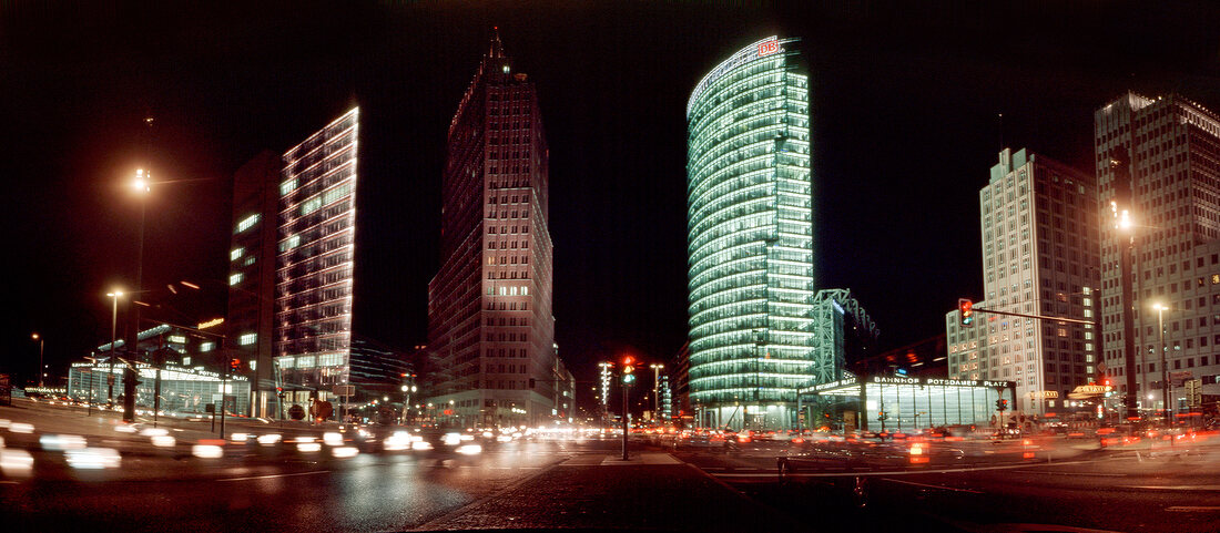 Panoramic view of busy street at night in Potsdamer Platz, Berlin, Germany