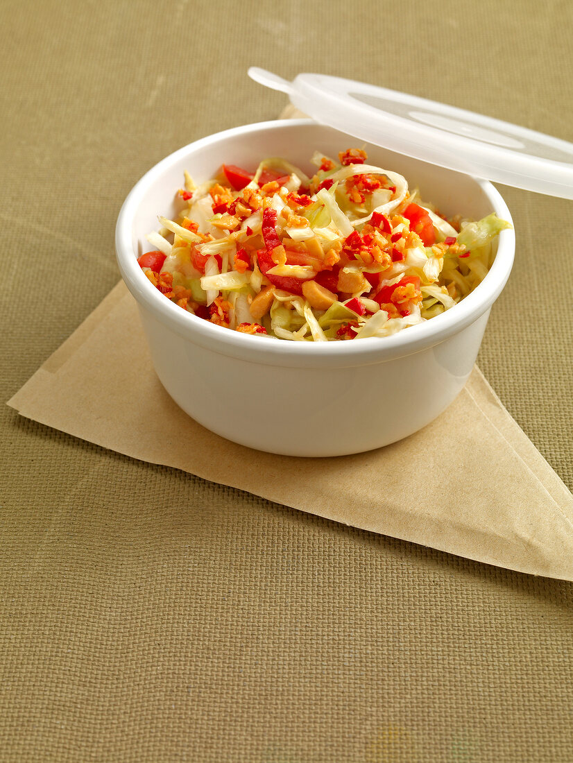 Spicy cabbage salad with peanuts in bowl