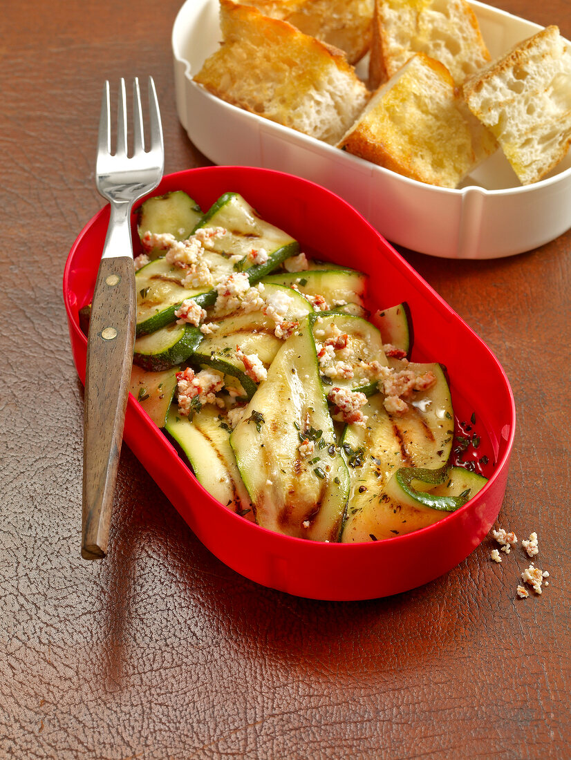 Grilled zucchini salad with sheep cheese in serving dish