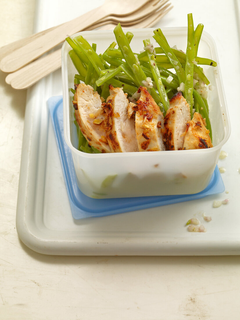 Green bean salad with ginger chicken on serving dish