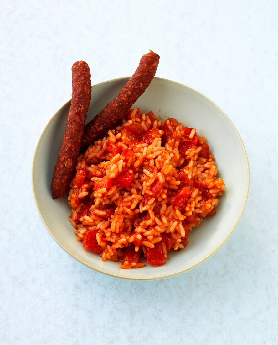 Paradise risotto with salami sticks in bowl