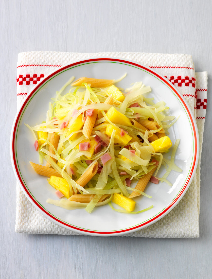 Plate of pineapple herb fleckerln on folded napkin