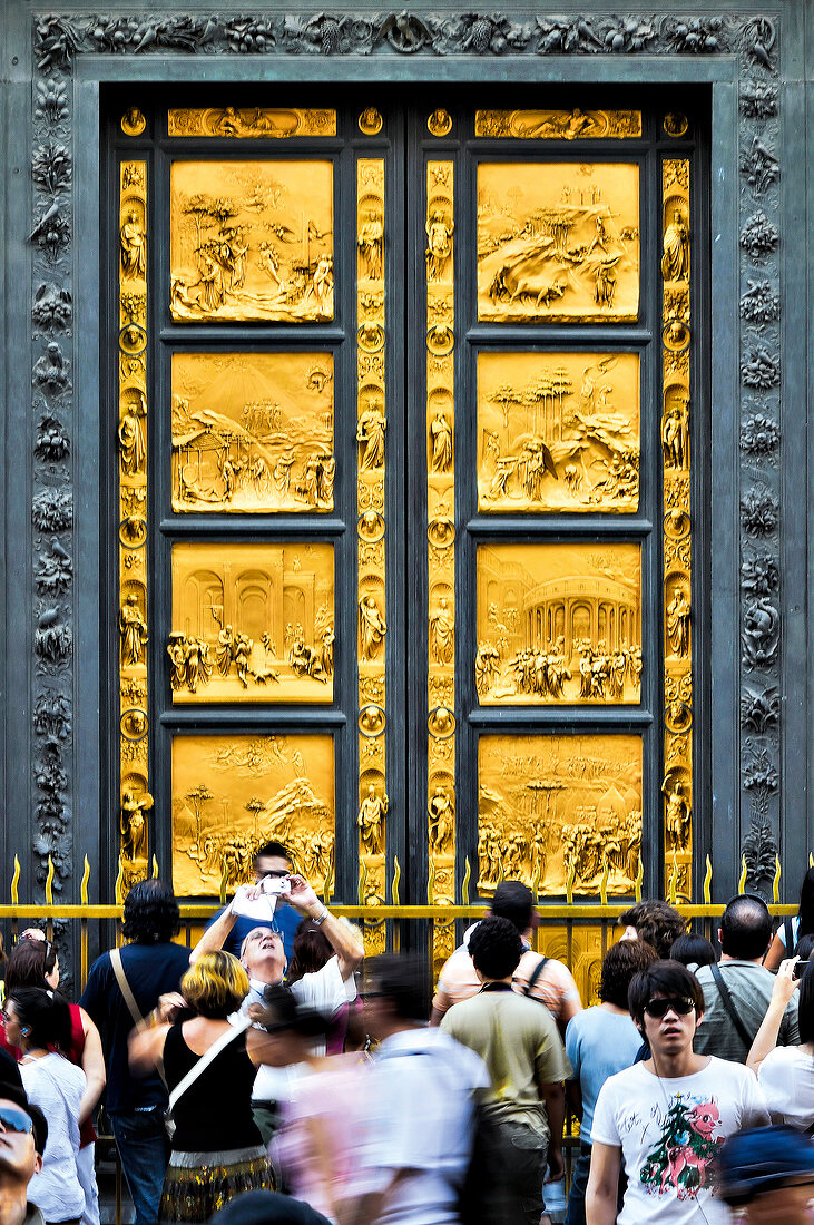 Tourists at East portal of the Baptistery of San Giovanni, Florence, Italy