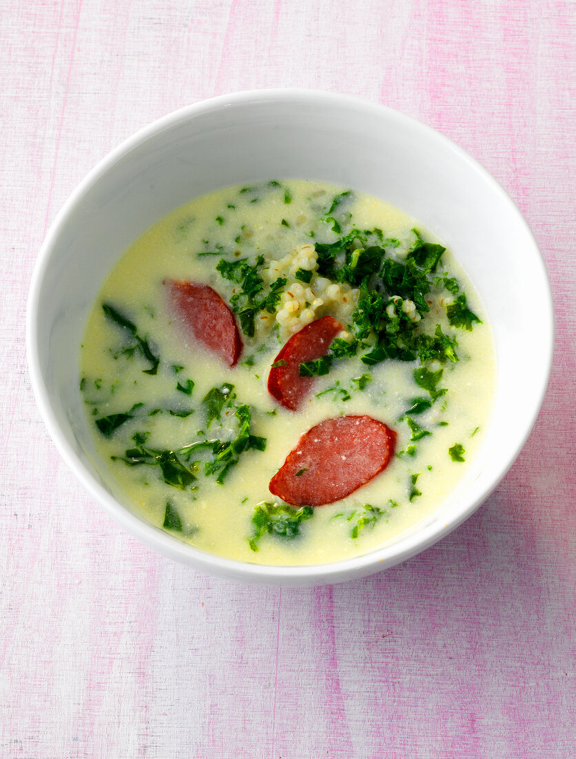 Bowl of green soup with meat