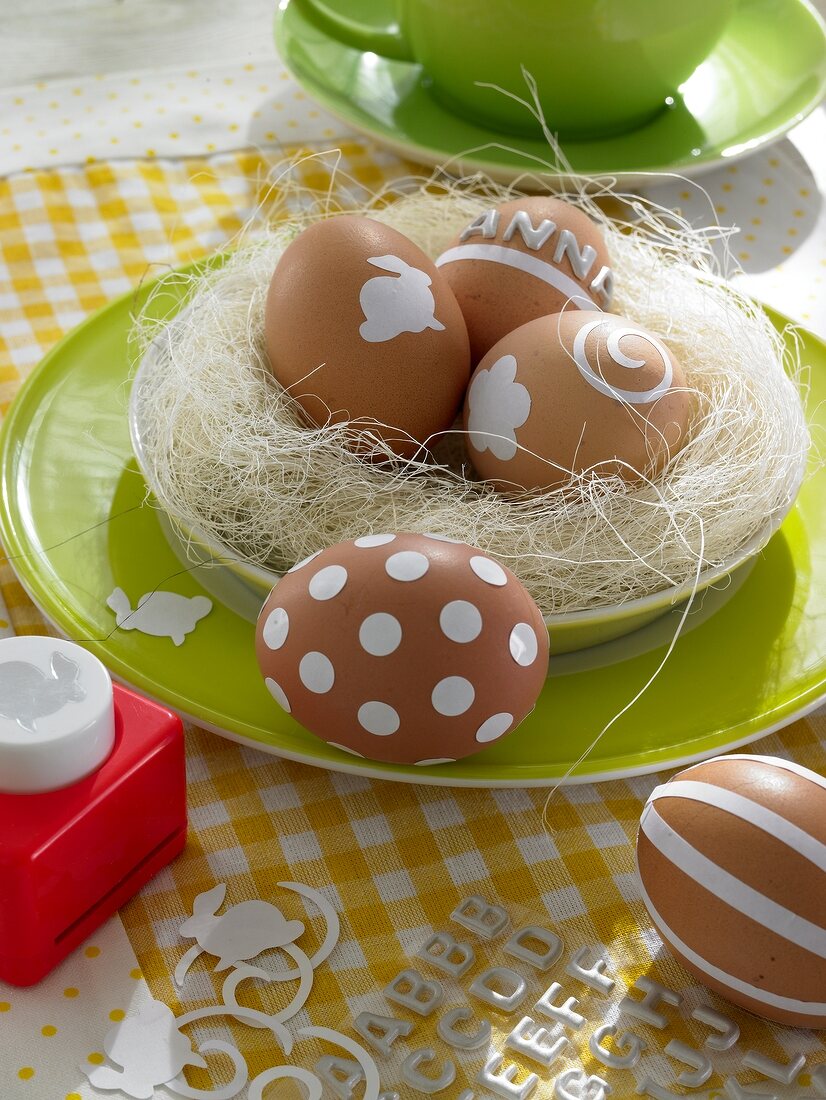 Easter eggs in nest of straw on breakfast plate