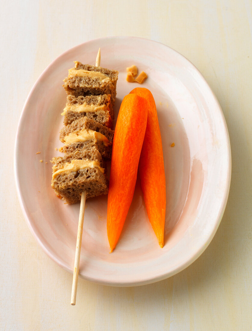 Bread skewers with peanut butter on plate