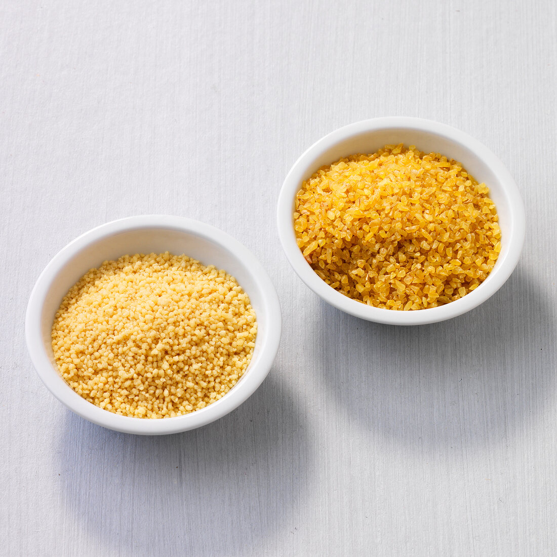 Uncooked couscous and bulgur in bowl