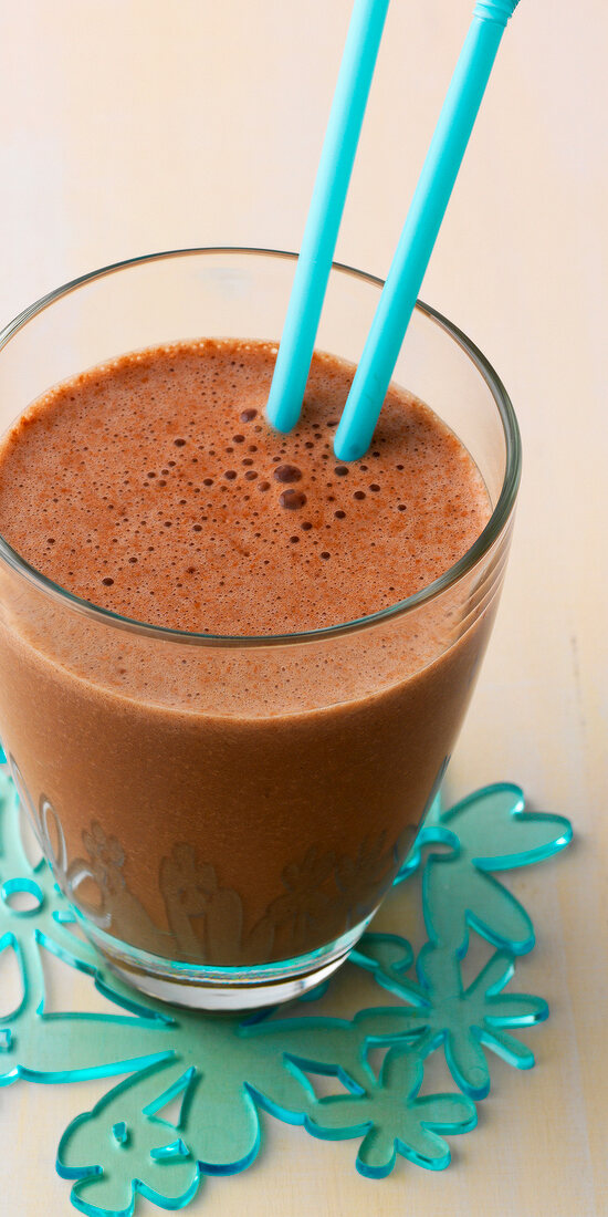 Close-up of banana chocolate smoothie in glass