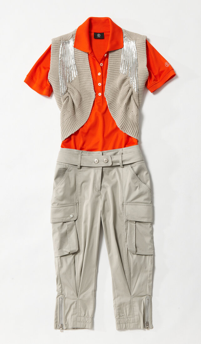 Sequined vest with cropped trousers and orange polo shirt on white background