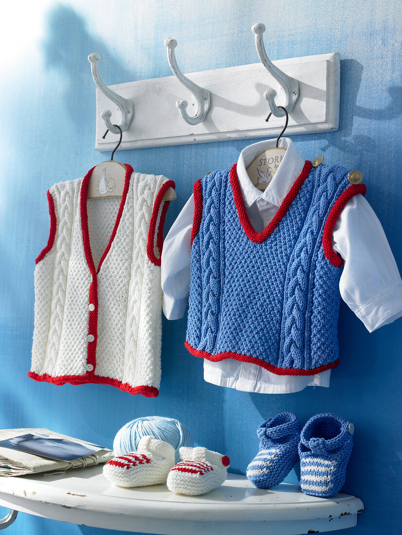 Vest and tank tops hanging on hangers from cotton blended yarn