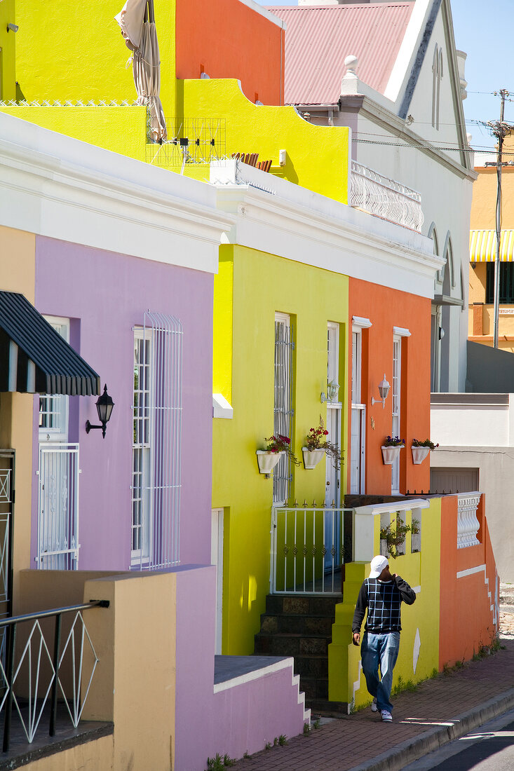 Man walking near colourful houses at Bo-kaap, Cape Town, South Africa