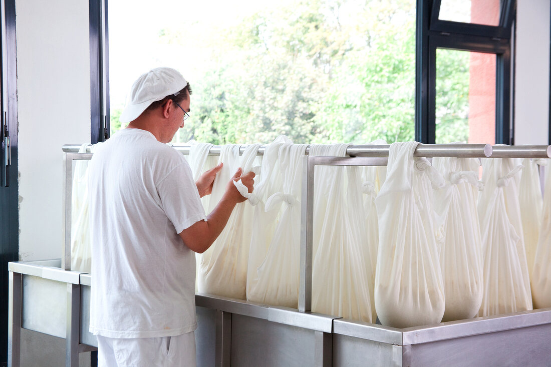 Man looking at bags of cheese