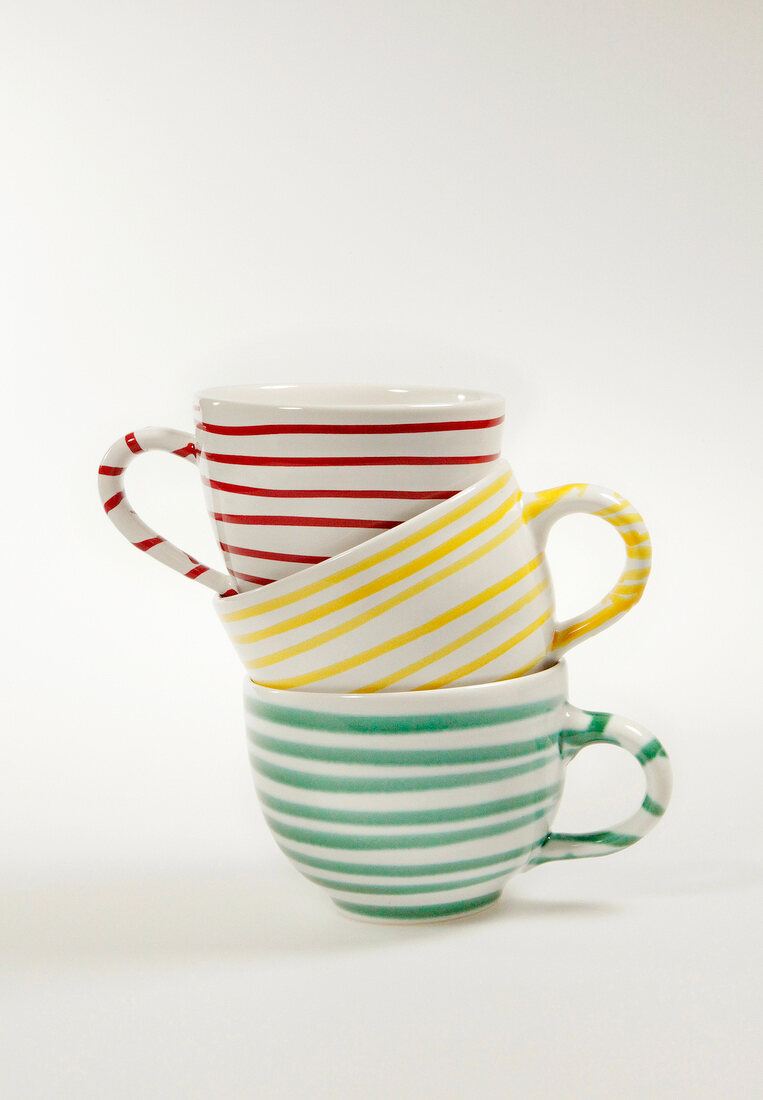 Striped cups in stack on white background