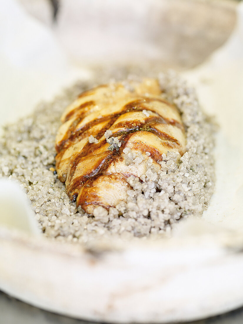 Close-up of foie gras in salt-ash crust on plate