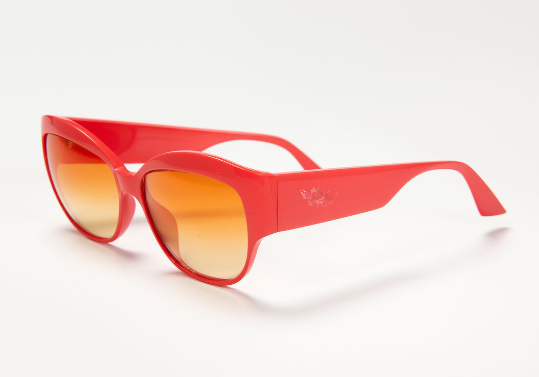 Orange sunglasses on white background