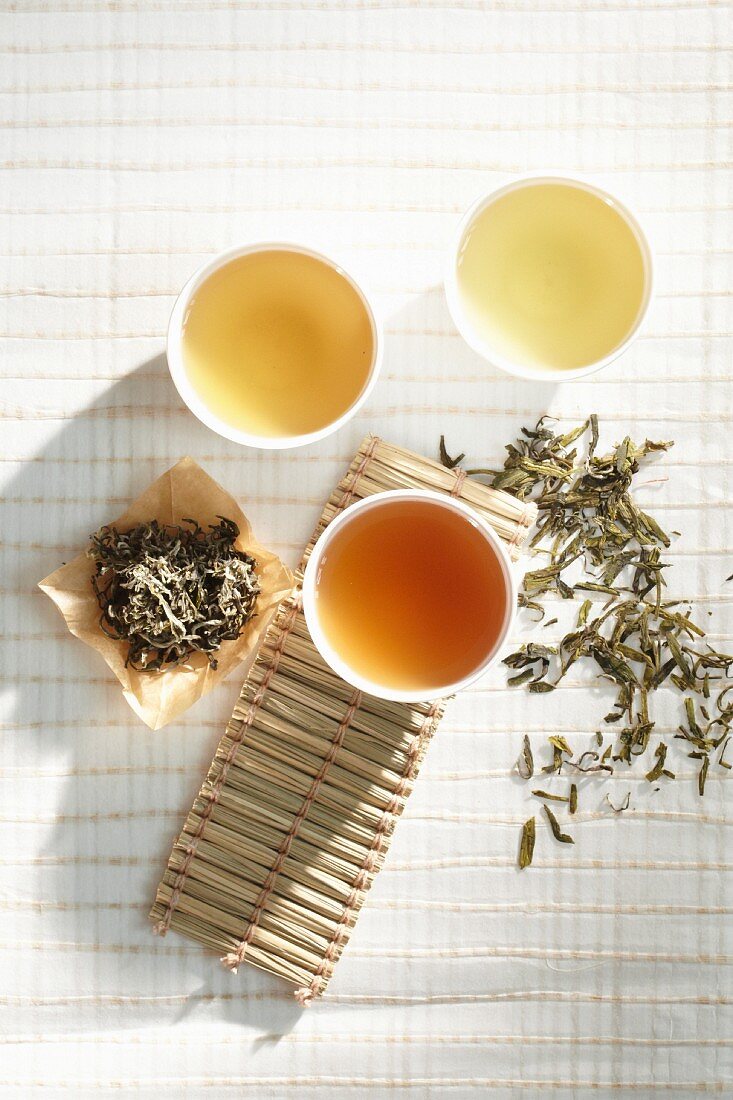 Tea cups with dried tea leaves on table