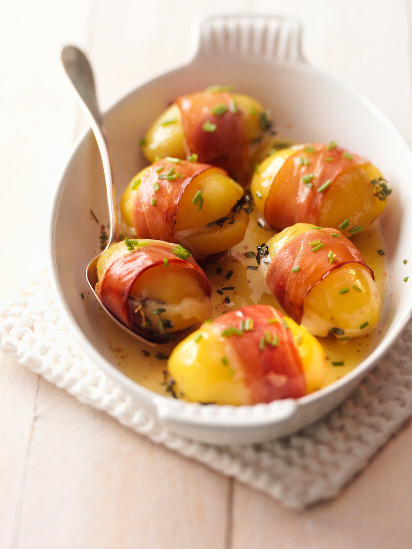 Stuffed potatoes with bacon and sauce on serving tray