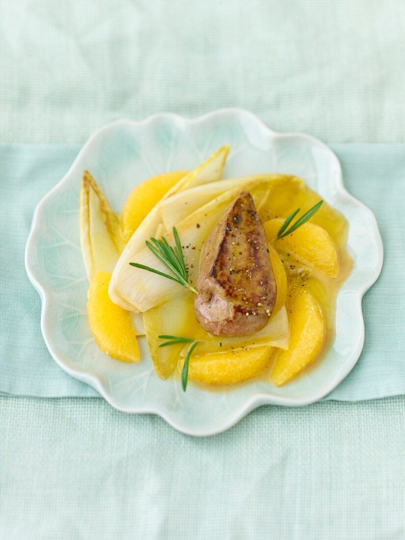 Fried calf's liver with chicory and oranges on pattern dish