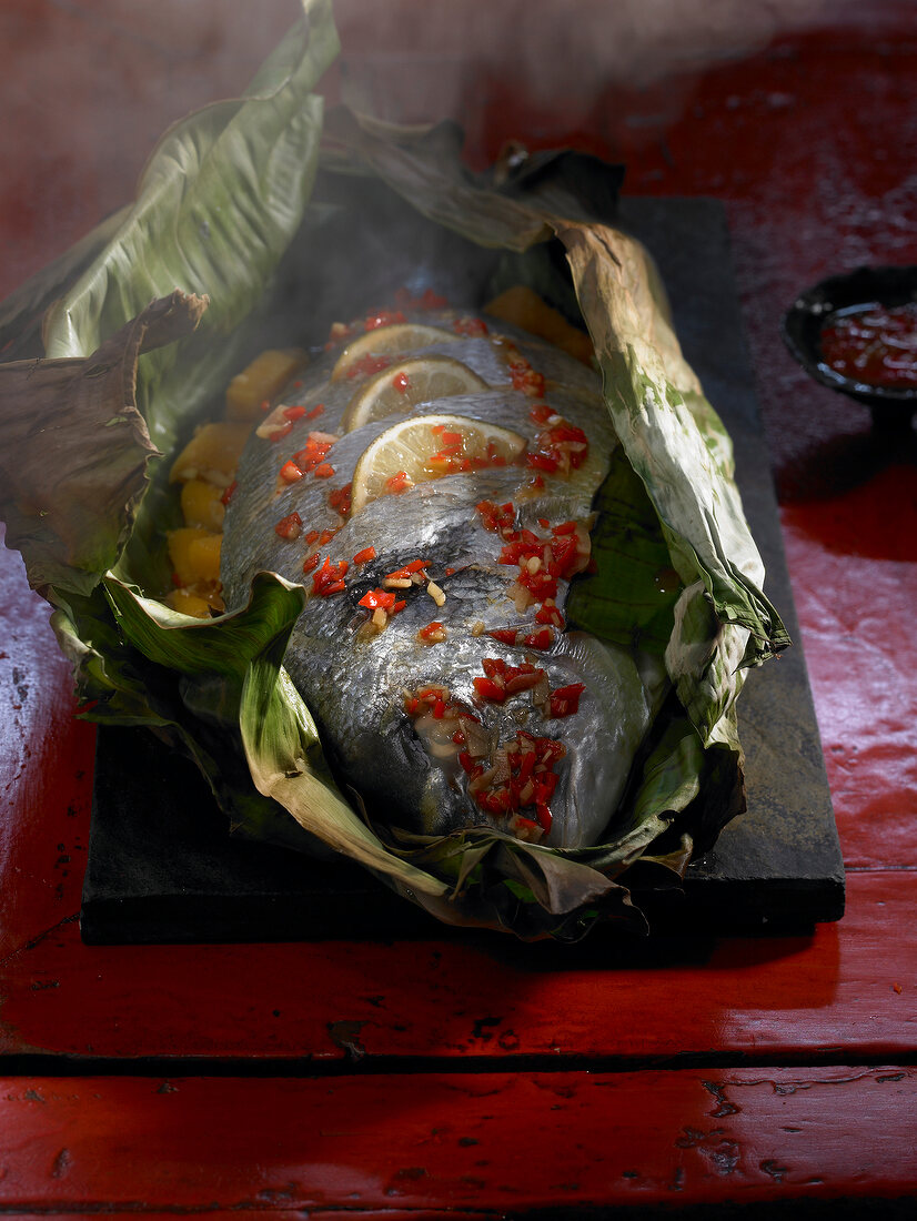 Sea bream and mango steamed in banana leaf