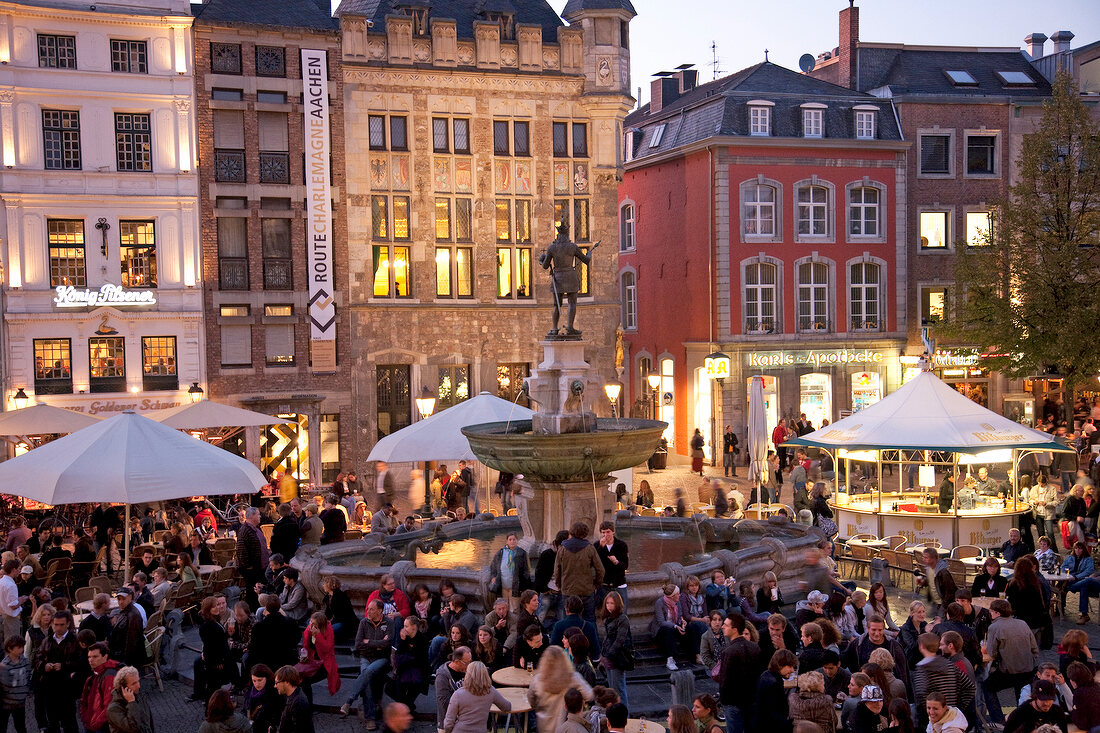 Crowd at Karlsplatz fountain in centre of market place at Aachen, Germany