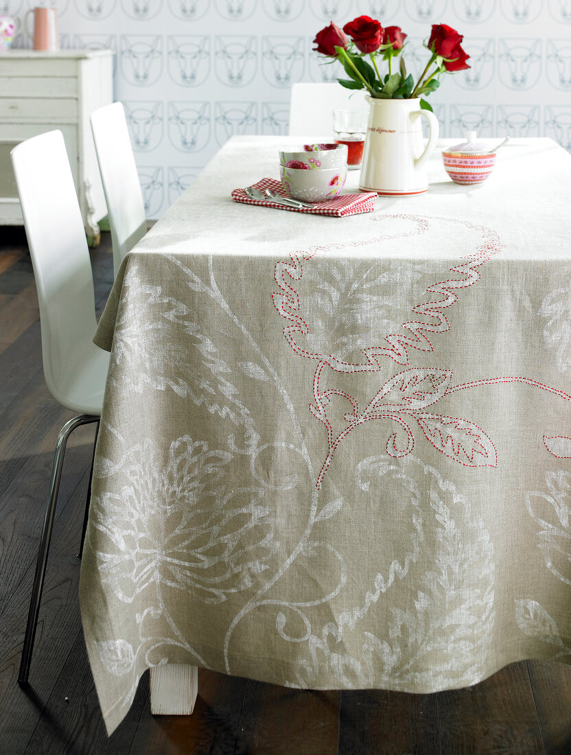Beige embroidered tablecloth with floral motifs