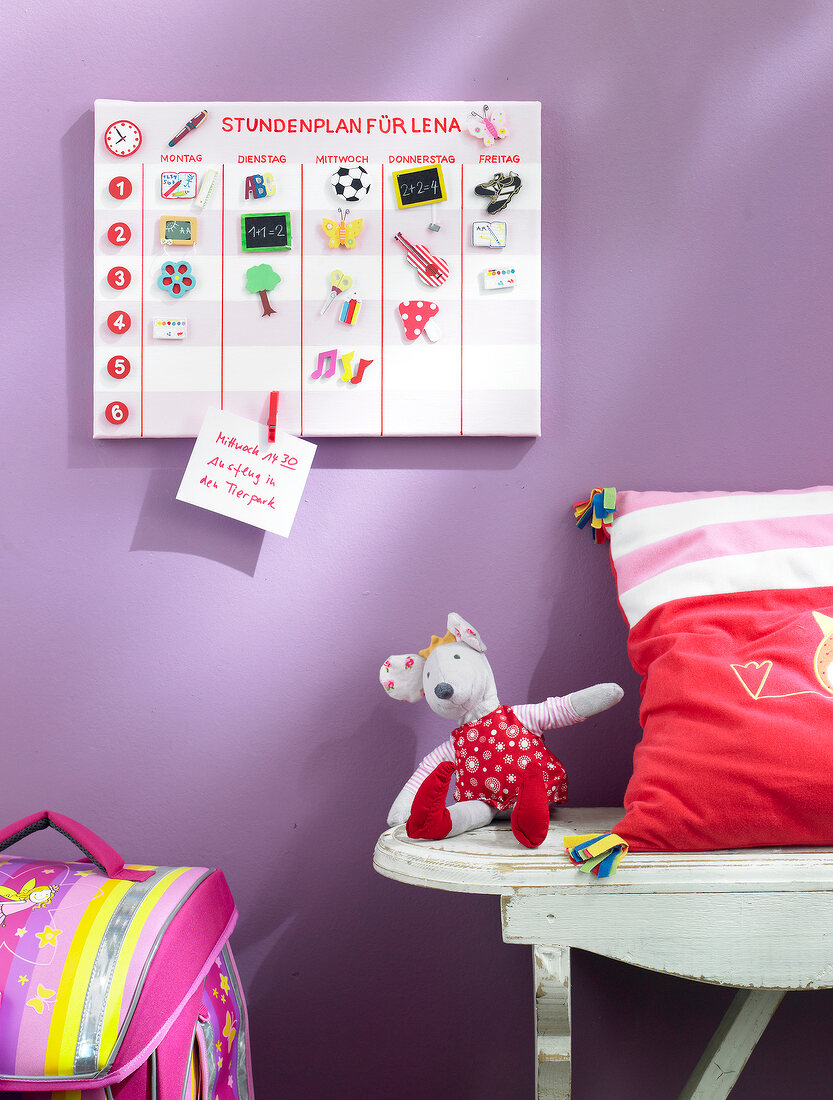 Magnetic board with timetable for children on purple wall