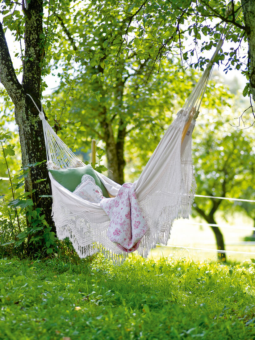Close-up of white hammock hanging on tree
