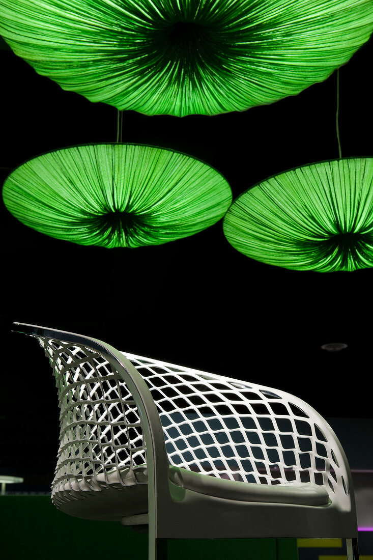 Room chair under green illuminated ceiling lights