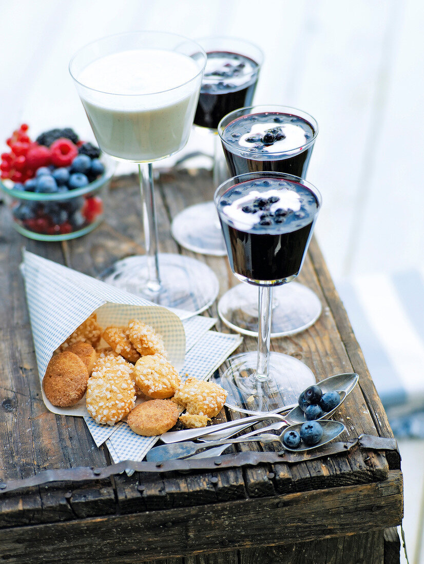 Blueberry grits in glass and Danish biscuits in tissue on wooden table