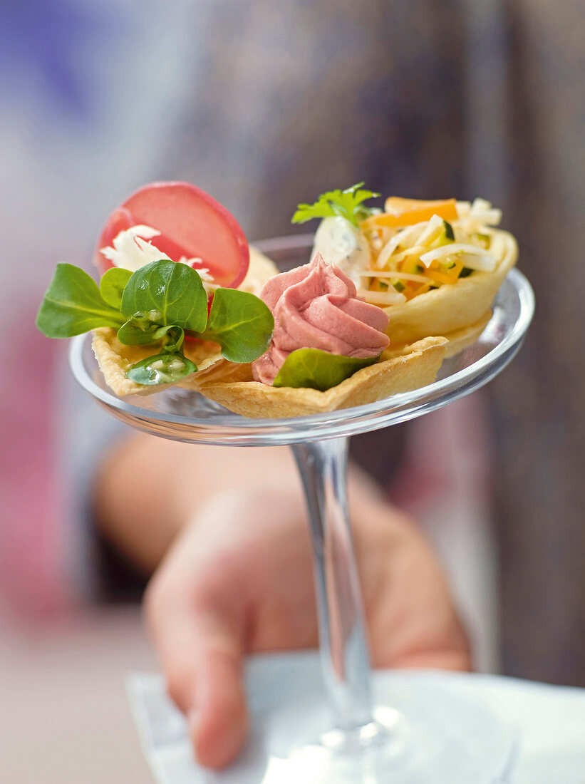 Close-up of tartlets with various fillings on cake stand