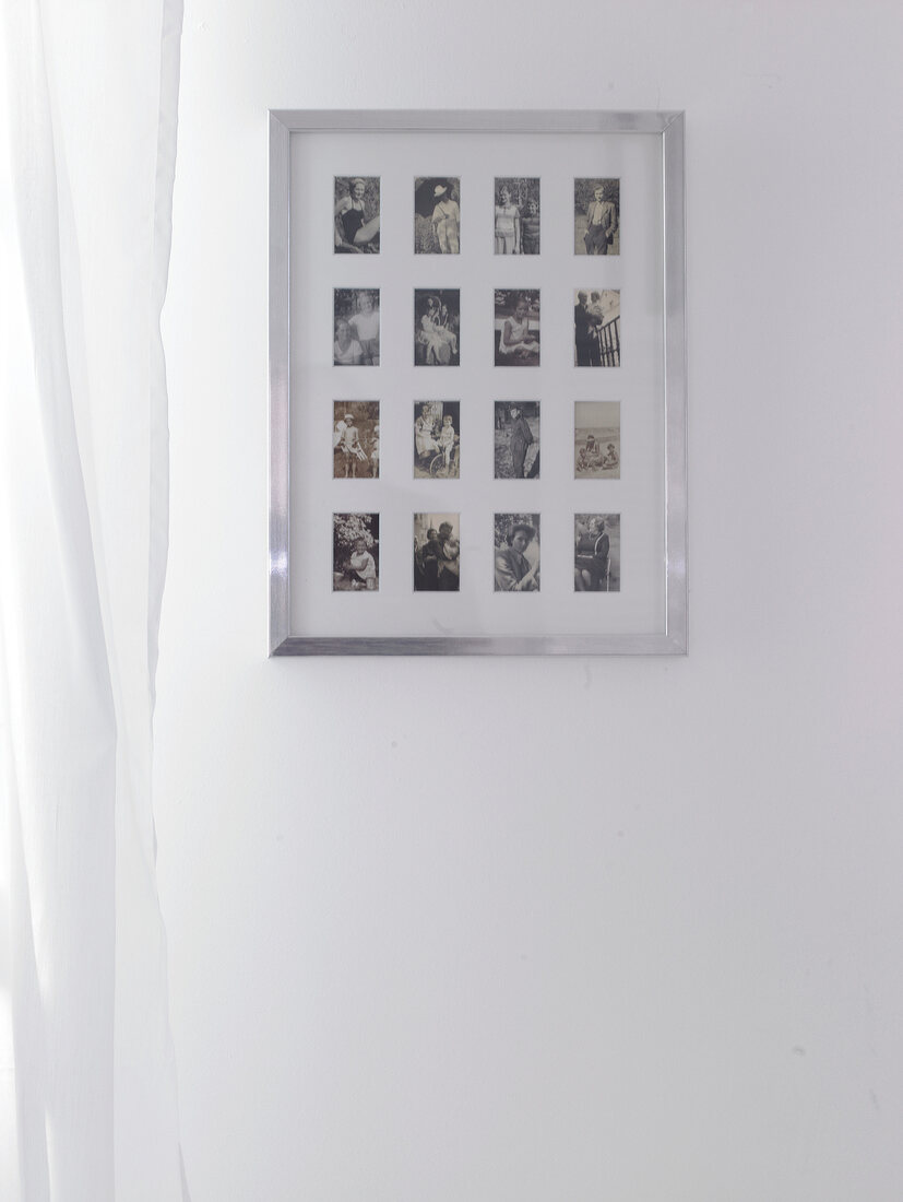 Small photos in large aluminium frame on white wall