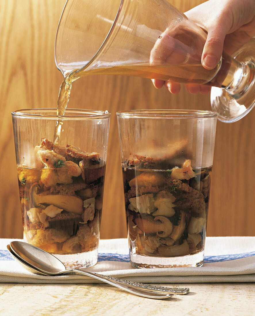 Bread soup with sweetbreads and mushrooms in jars