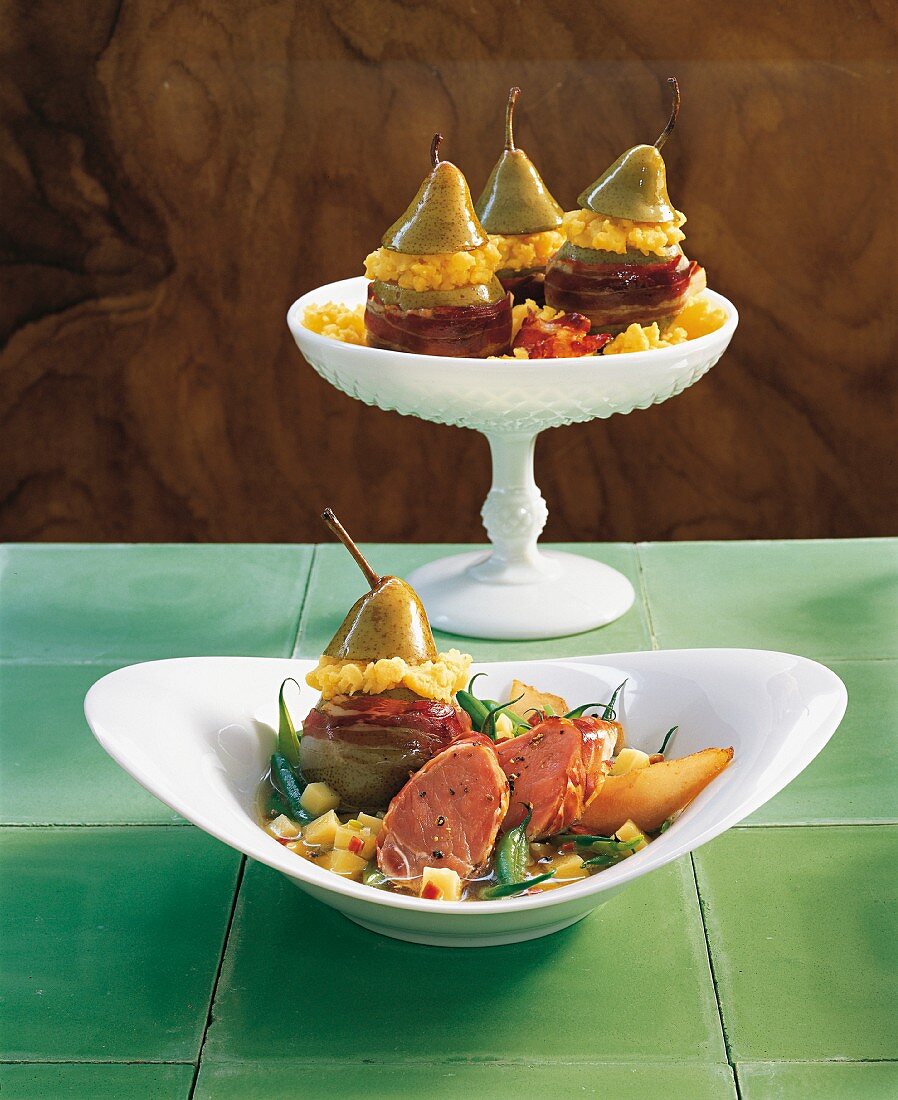 Pears, beans and bacon on a plate on a cake stand