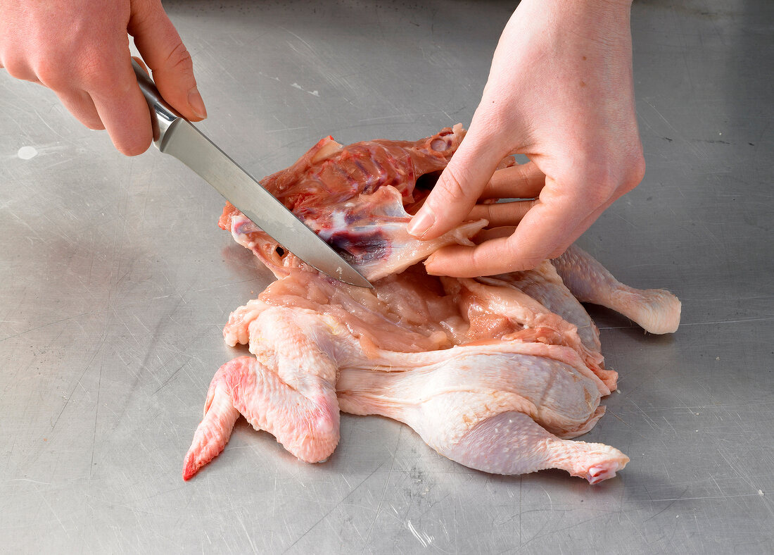 Cutting and boning raw chicken, step 3