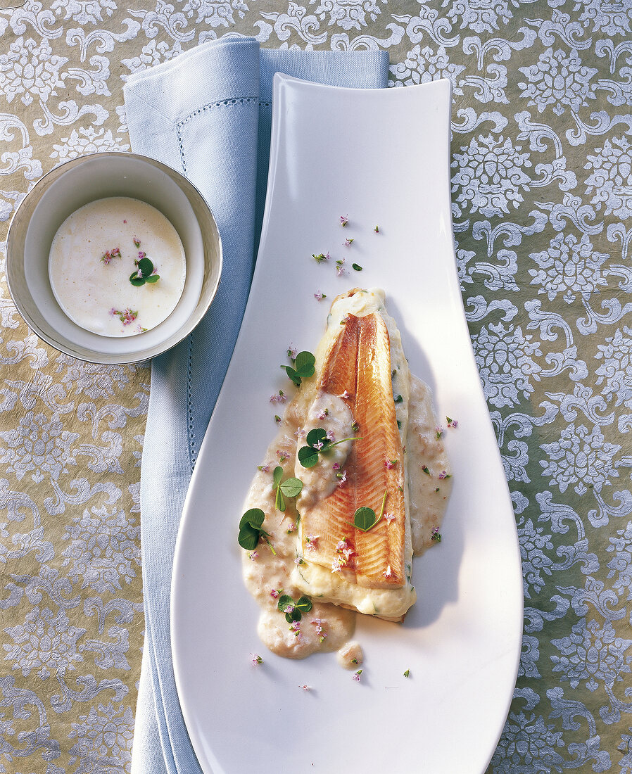 Close-up of char fillet with zander and mint in serving dish