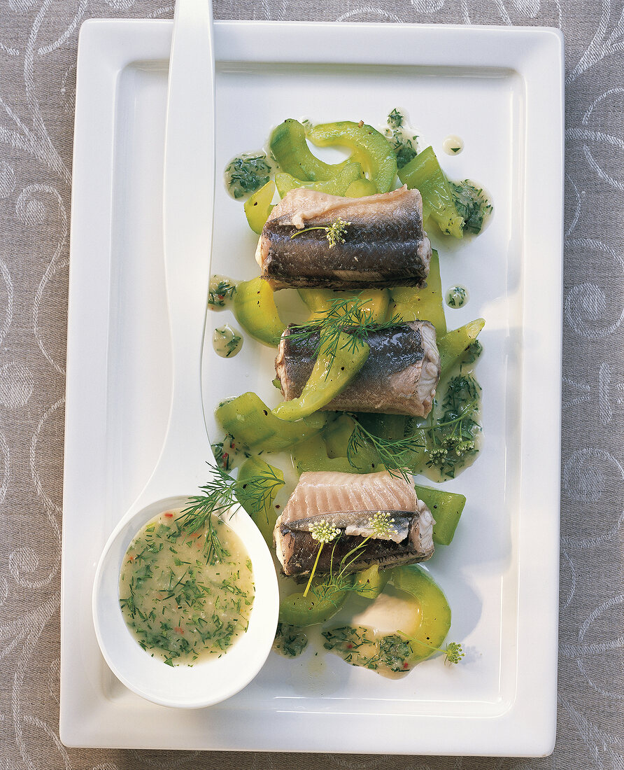 Green eel with dill sauce in spoon on tray