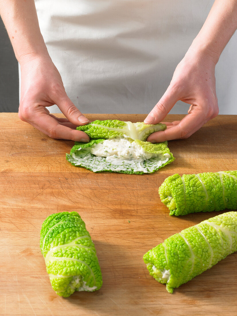 Rolling up savoy cabbage leaves in roulades for preparation of cabbage rolls, step 3