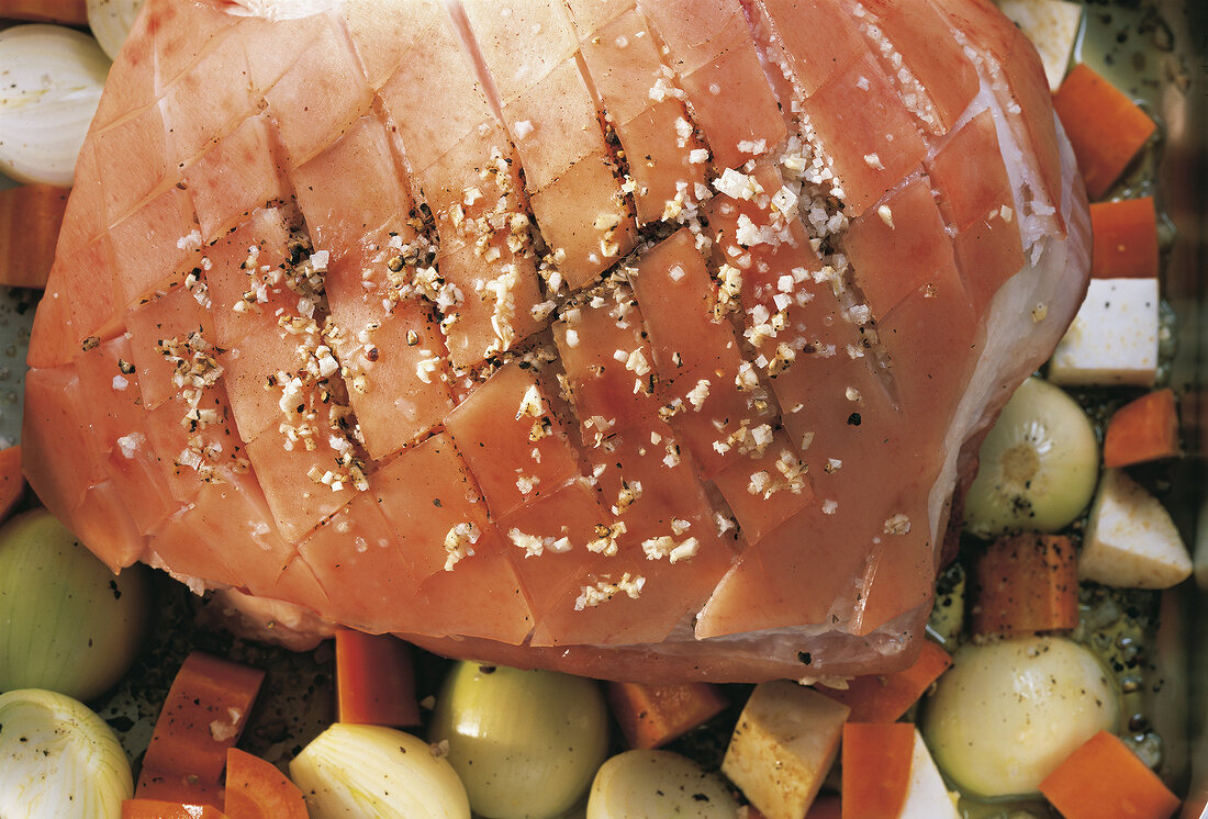 Close-up of juicy piece of meat with spices on vegetables