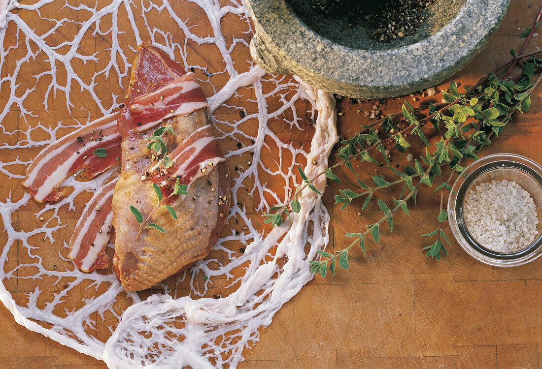 Variety of meat, ham and herbs on wooden surface, overhead view