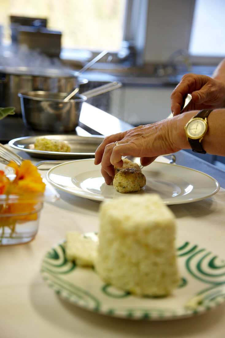 Graukasnocken with brown butter being served on plate