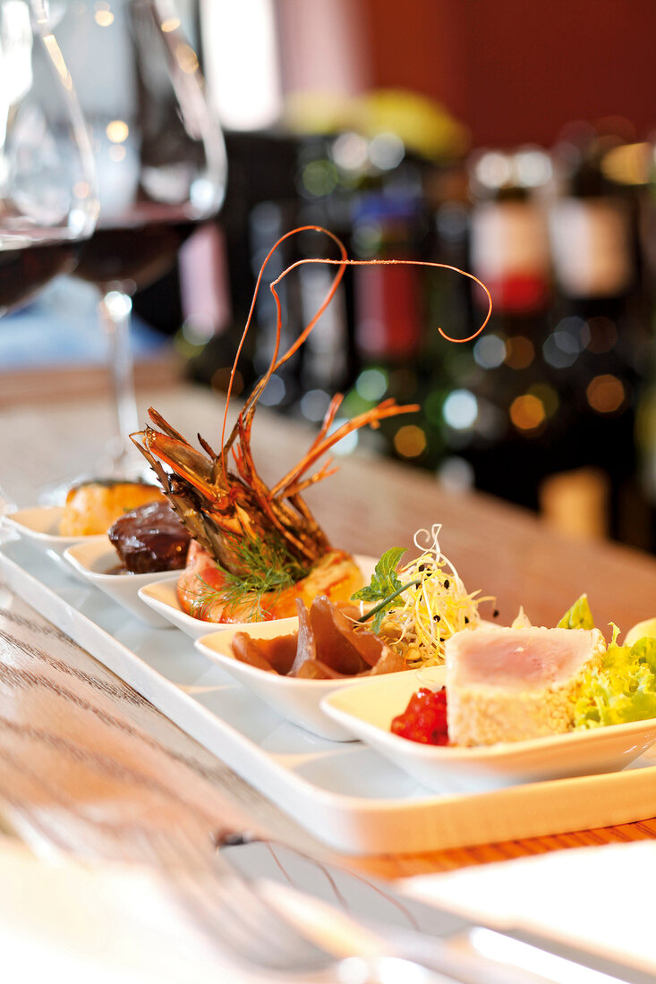 Tapas with Tuna sashimi, beef cheek and prawn on serving dish