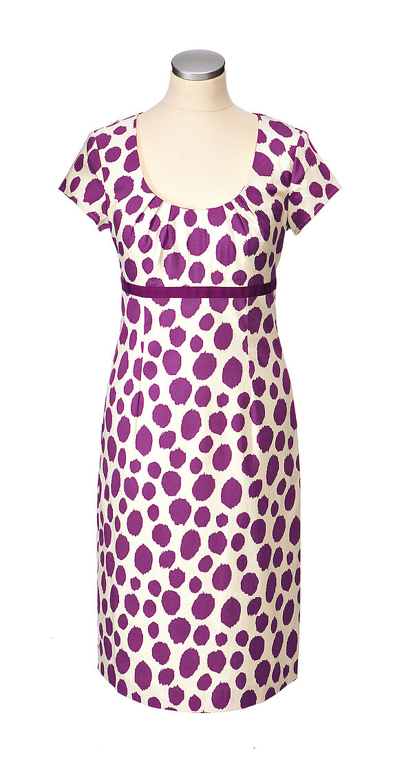 Close-up of purple sheath dress with polka dots on mannequin