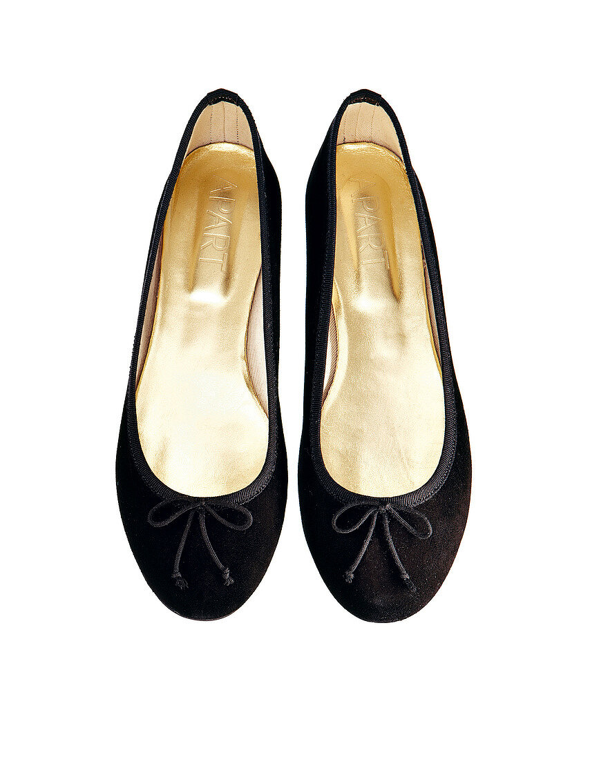 Close-up of black ballerinas suede on white background
