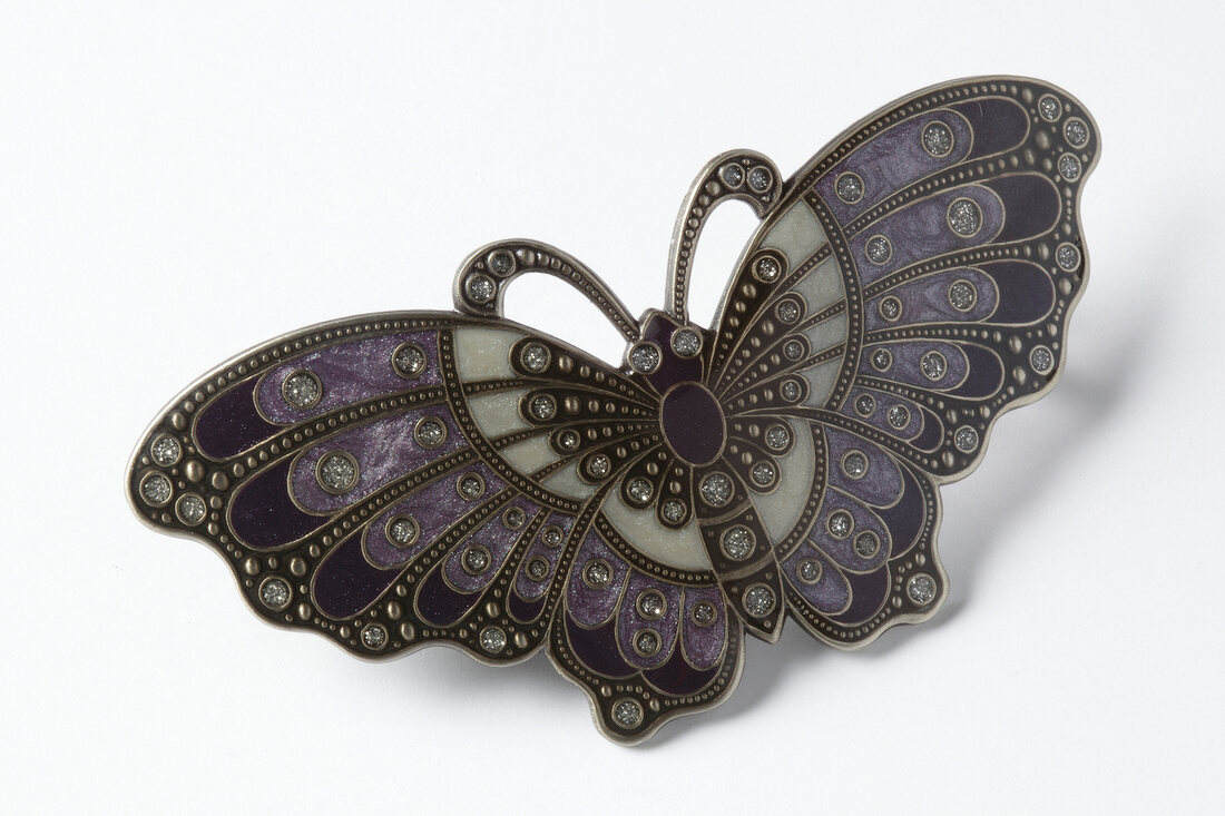 Close-up of butterfly shaped barrette on white background